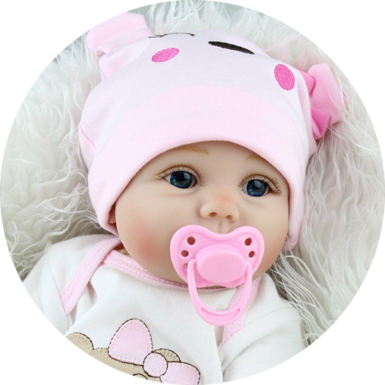 A baby dressed in pink with a matching hat and pacifier lies on a fluffy white blanket.